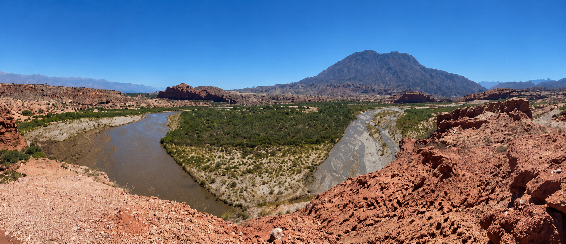 Scenic view of the Kachi lithium project in Argentina with arid salt flats, distant mountains and a project team member observing operations
